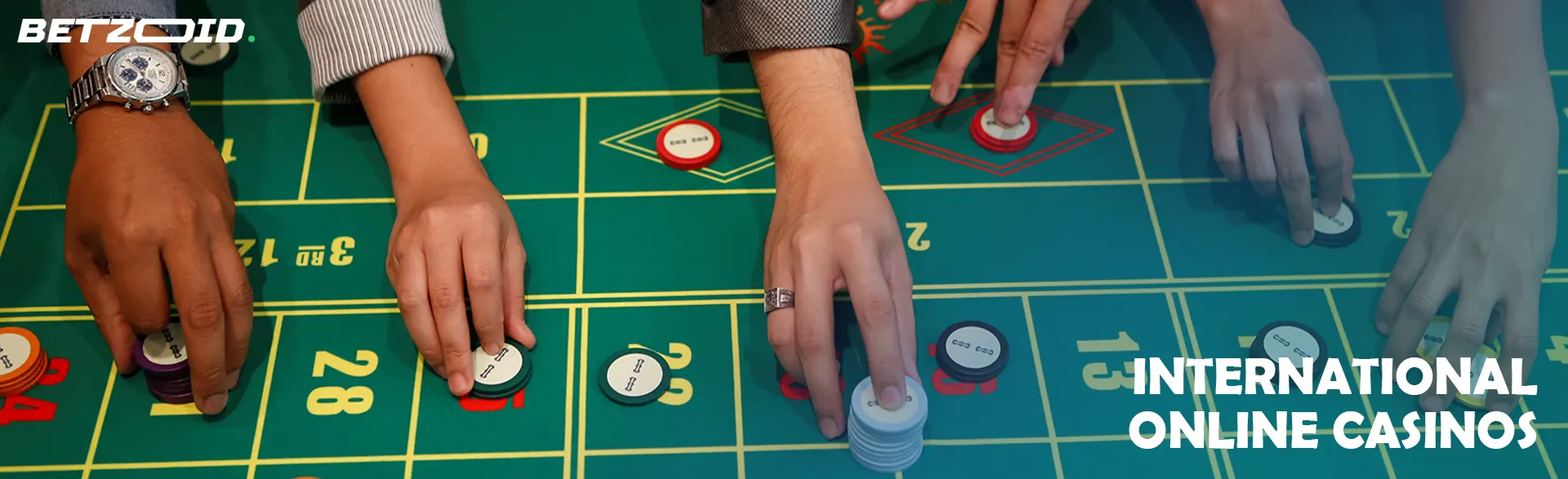 Players place bets with chips on a casino table.