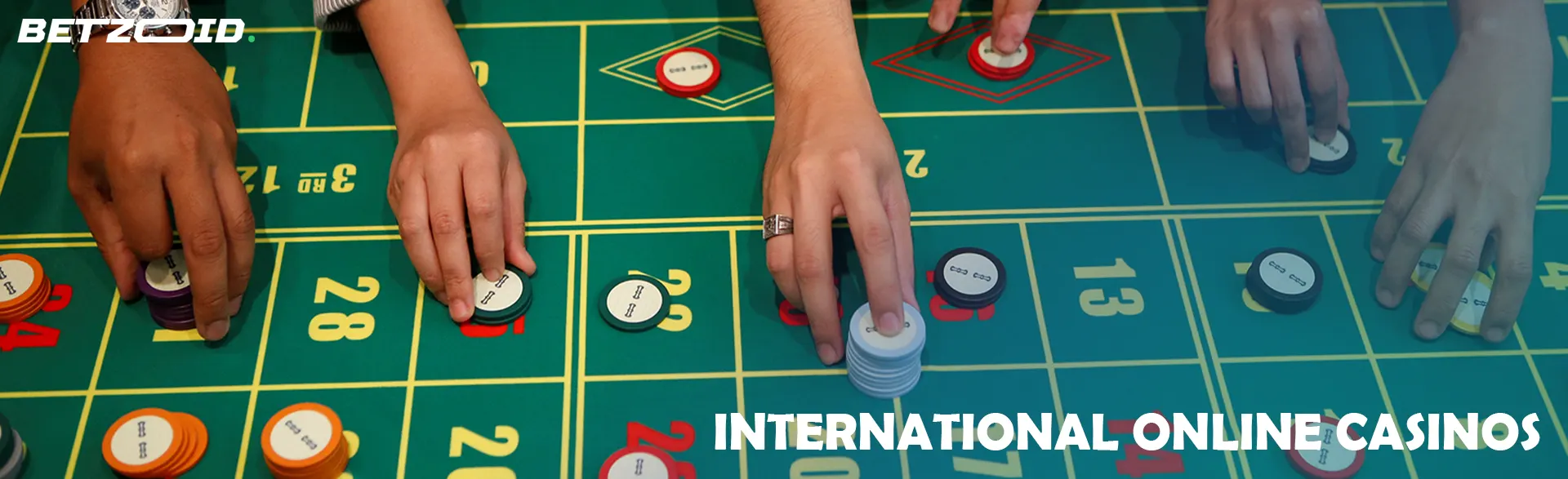 Players place bets with chips on a casino table.