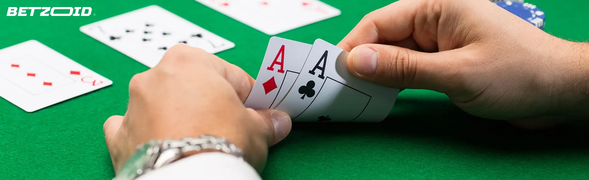 A player holds cards on the casino table.
