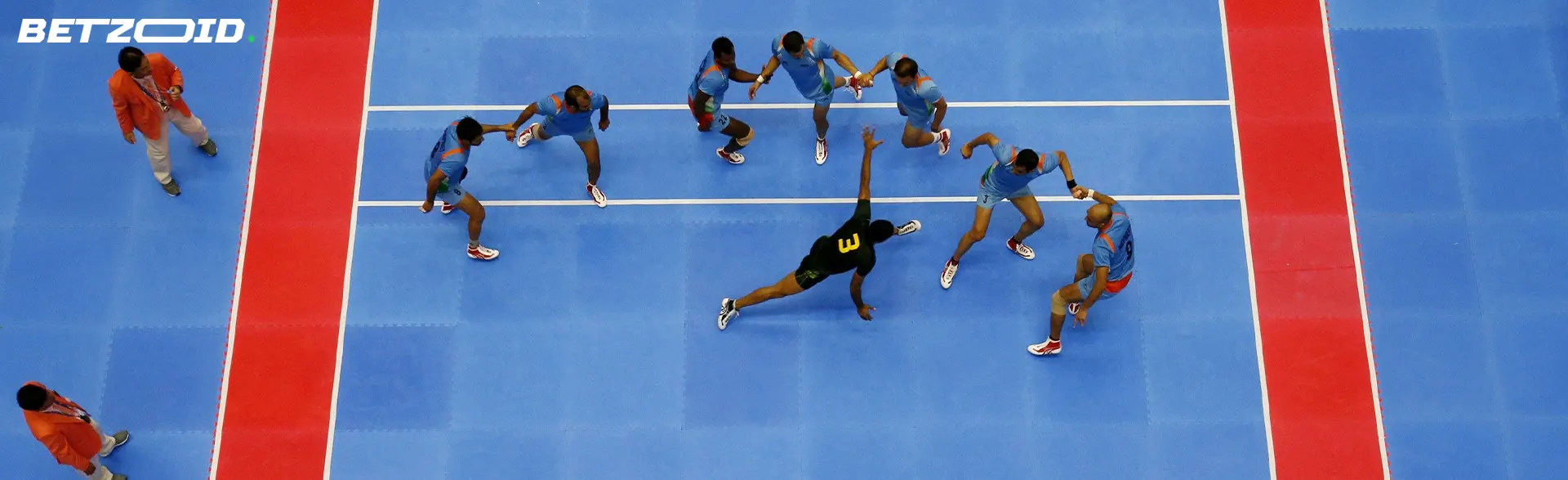 A team of kabaddi players on the field during a game.