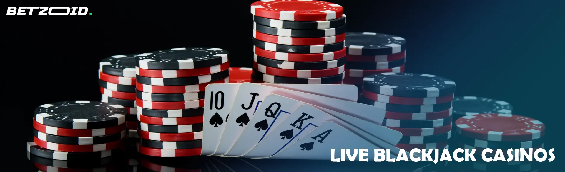 Pile of chips and cards on a dark background.