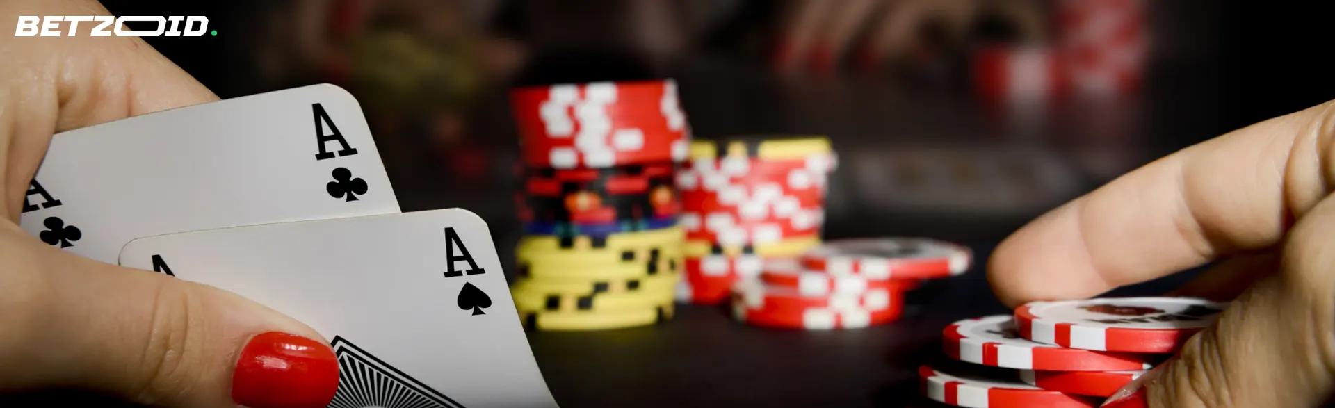 The player holds cards on the background of casino chips.