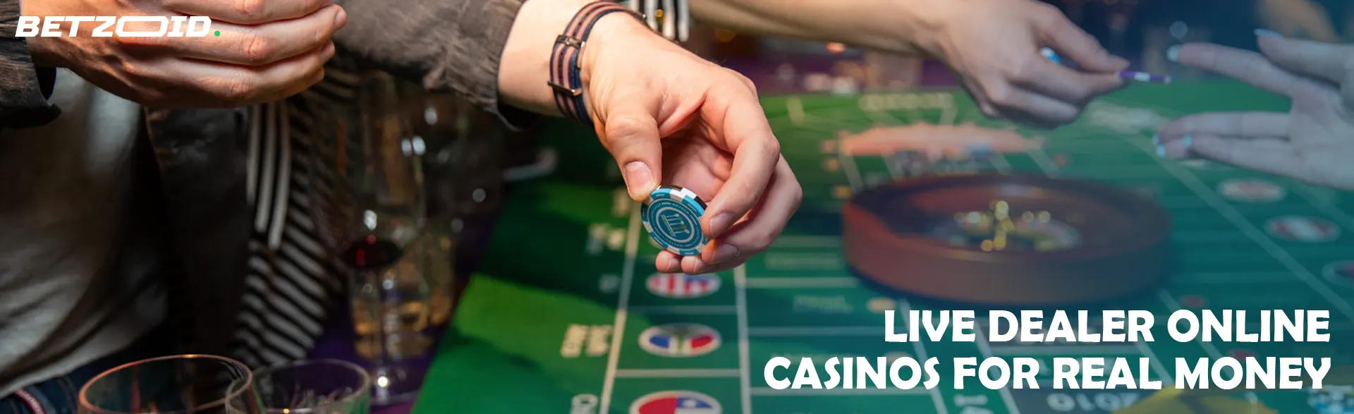 Players place bets with chips on the casino table.