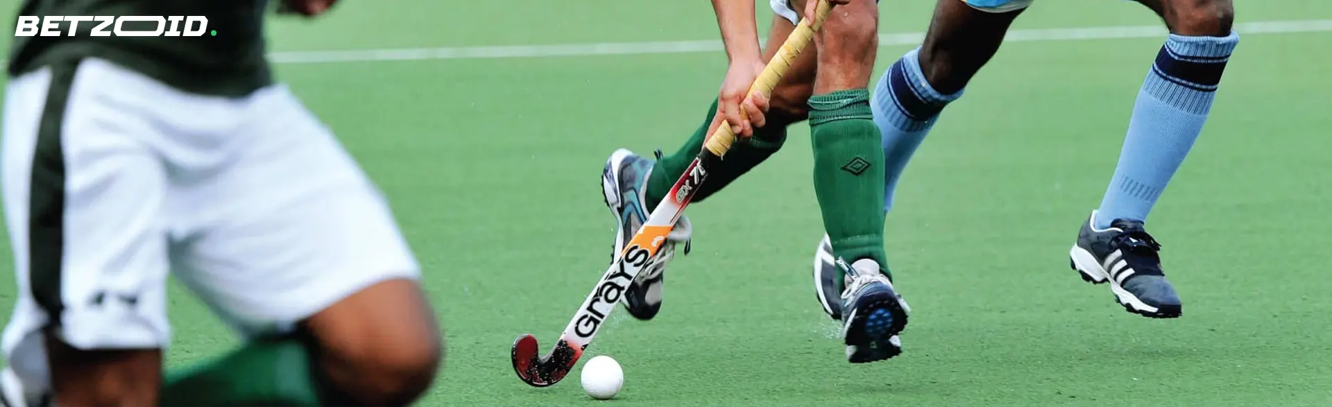 Field hockey players in action during a game.