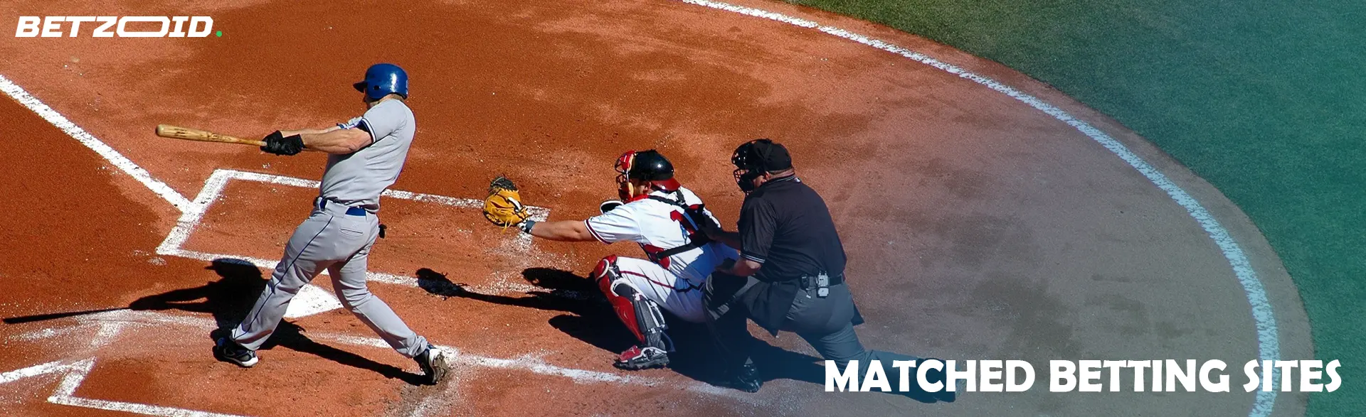 A baseball player swings the bat to hit the ball.