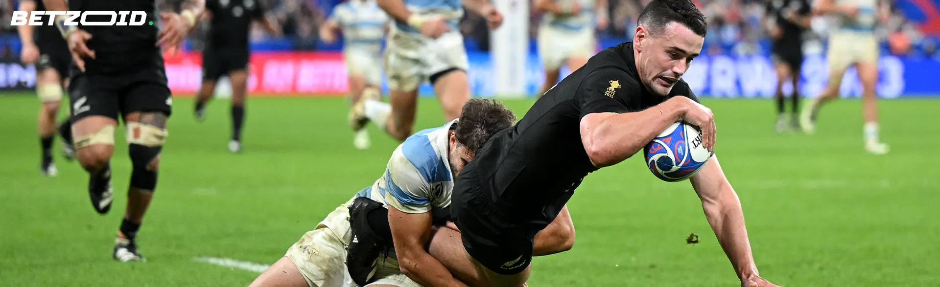 Rugby players fight for the ball during a game.