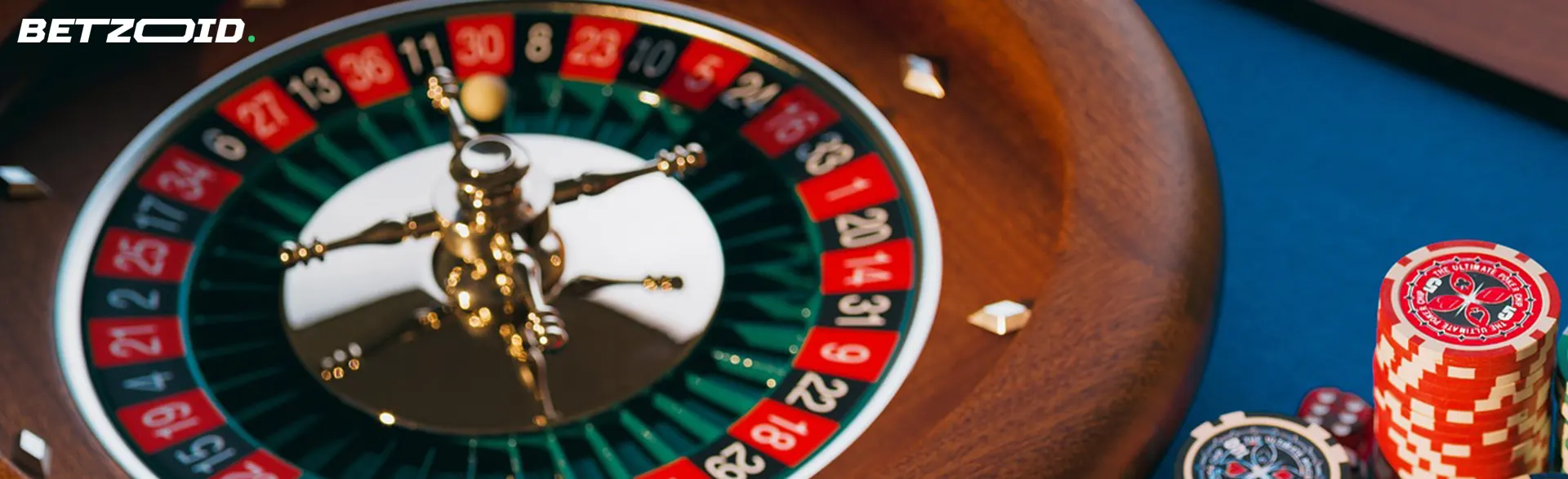 Roulette wheel next to casino chips.