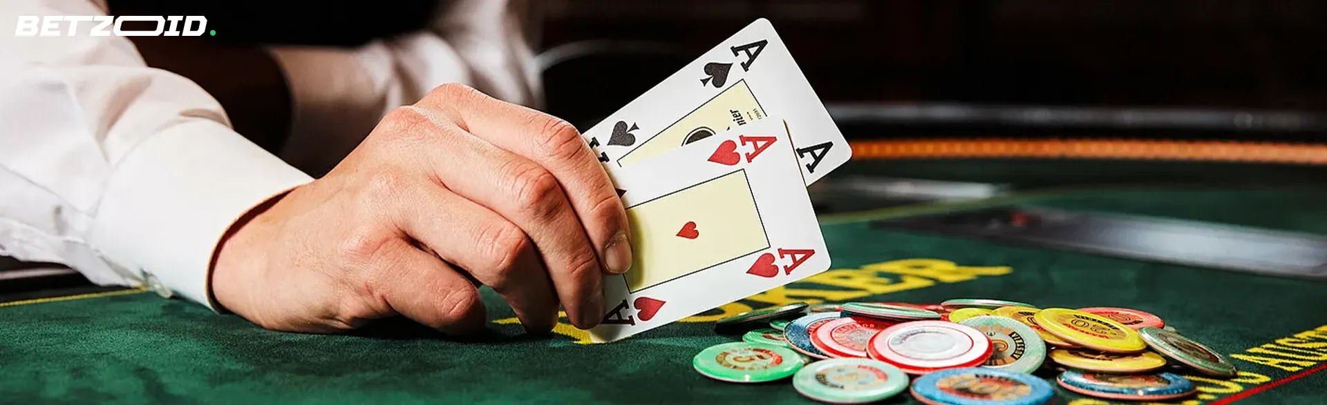 The player keeps two ace cards on the table next to the chips.