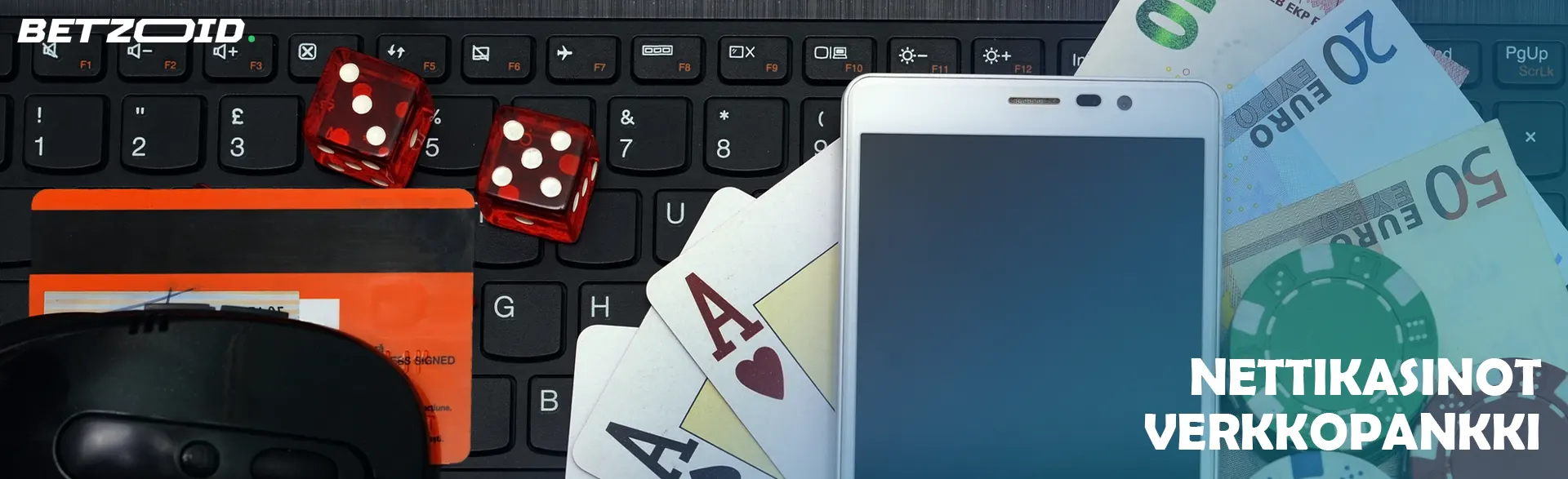 Näppäimistöllä on älypuhelin, rahaa, pelikortteja, noppia ja pankkikortti. 