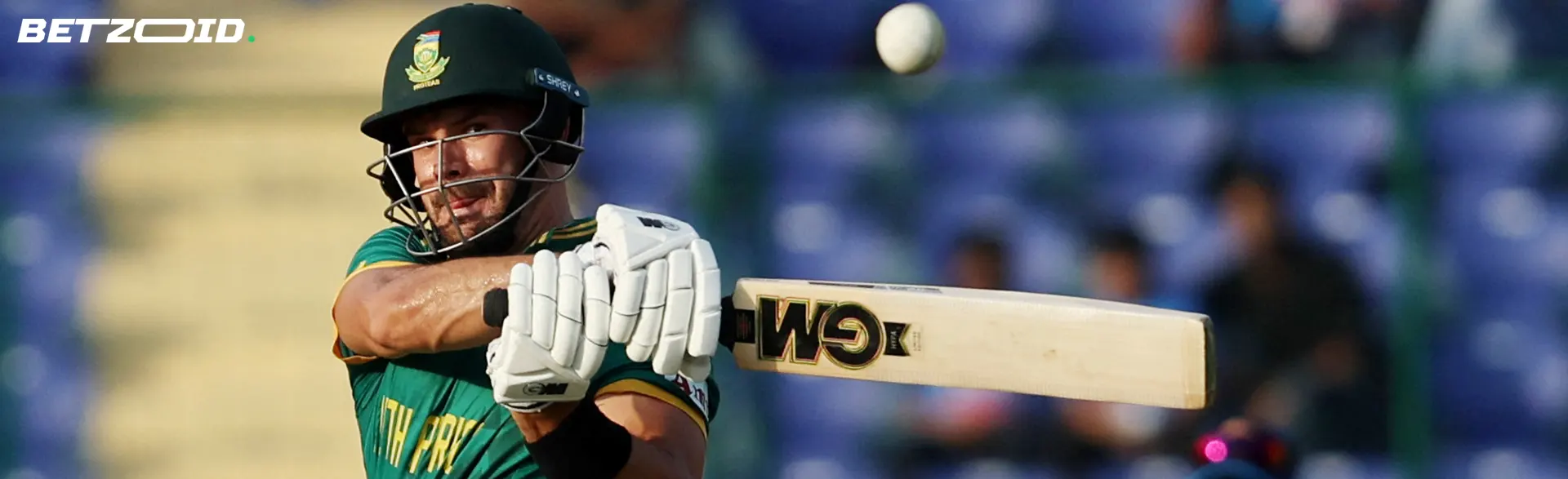 A cricket player hits the ball with a bat.