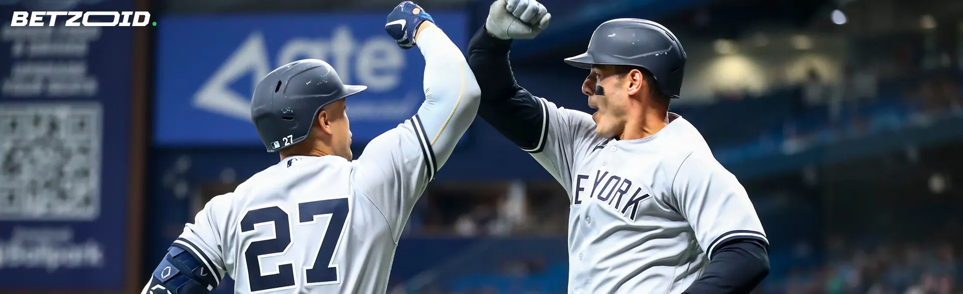 Baseball players greet each other with elbows.