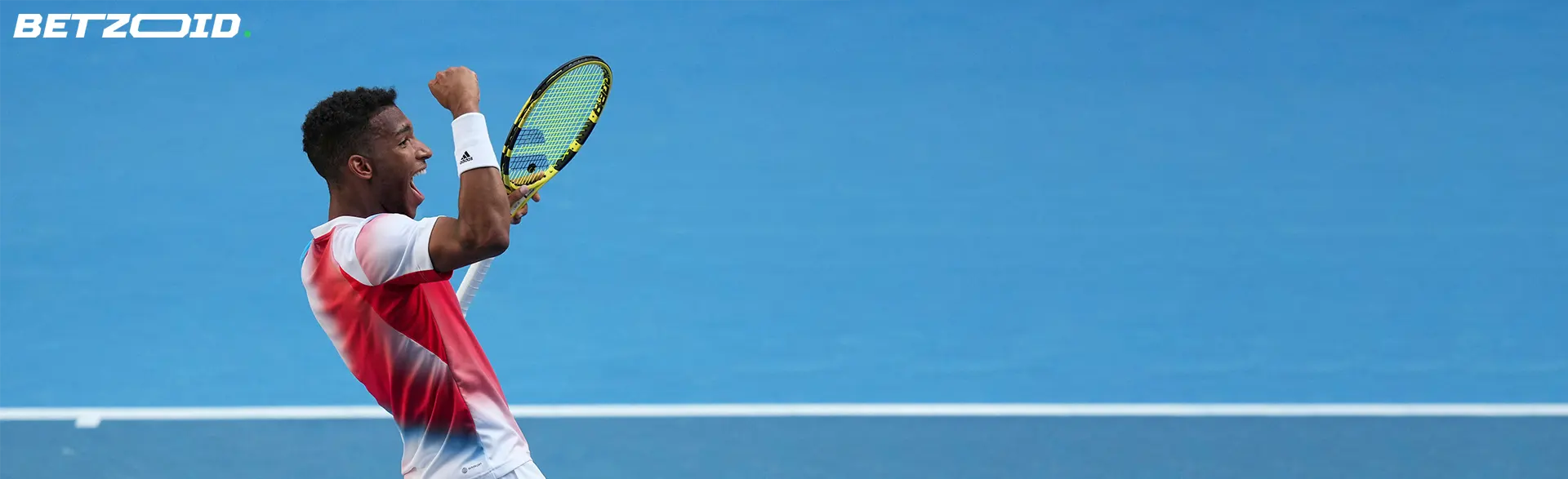 A tennis player celebrating on a blue court, representing Newfoundland online betting sites.