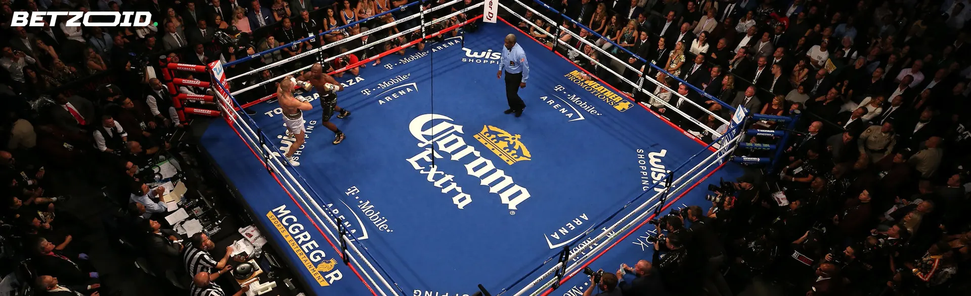 Boxers fight in the ring during a fight.