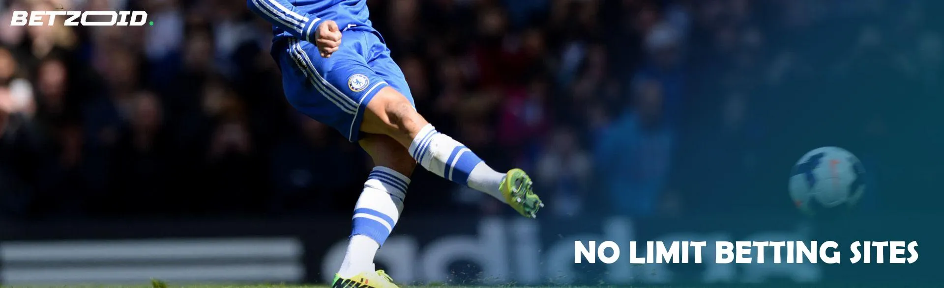 A football player kicks the ball during a game.