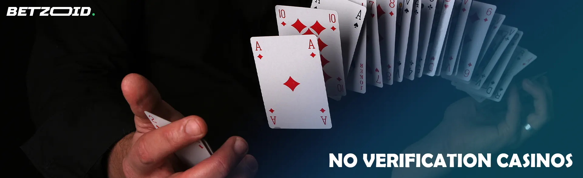 A man shuffles cards on a dark background.