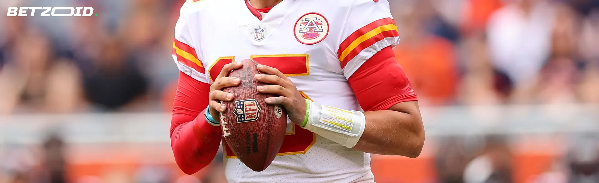 Jogador de futebol americano com uma bola nas mãos.