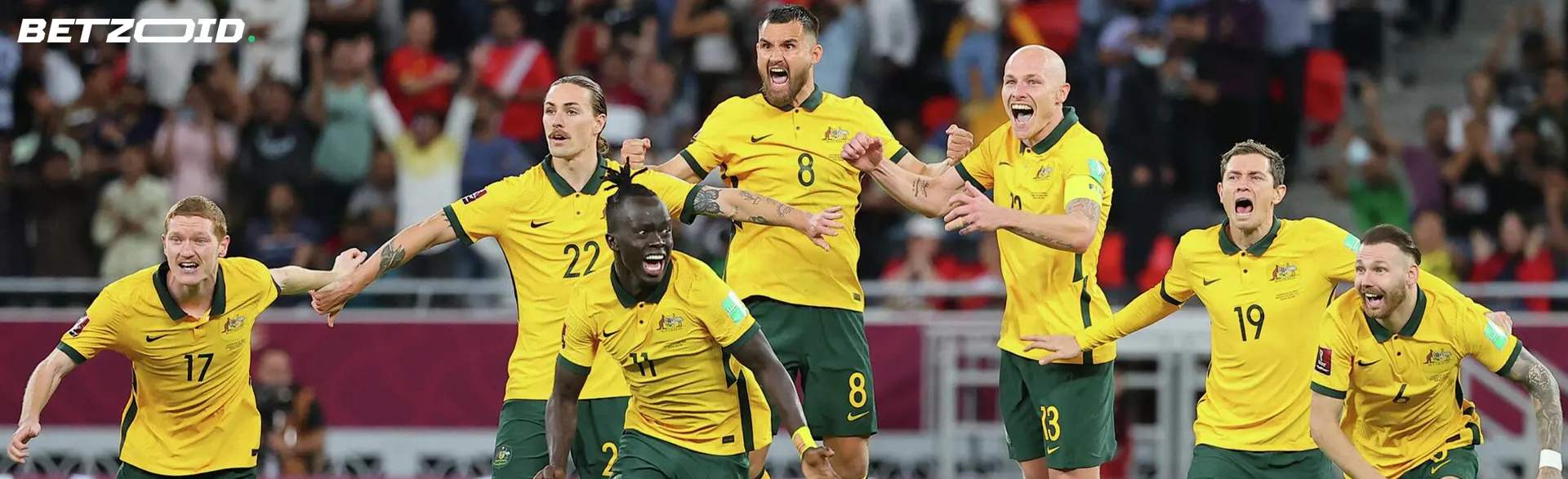 Australian football players celebrate the victory.