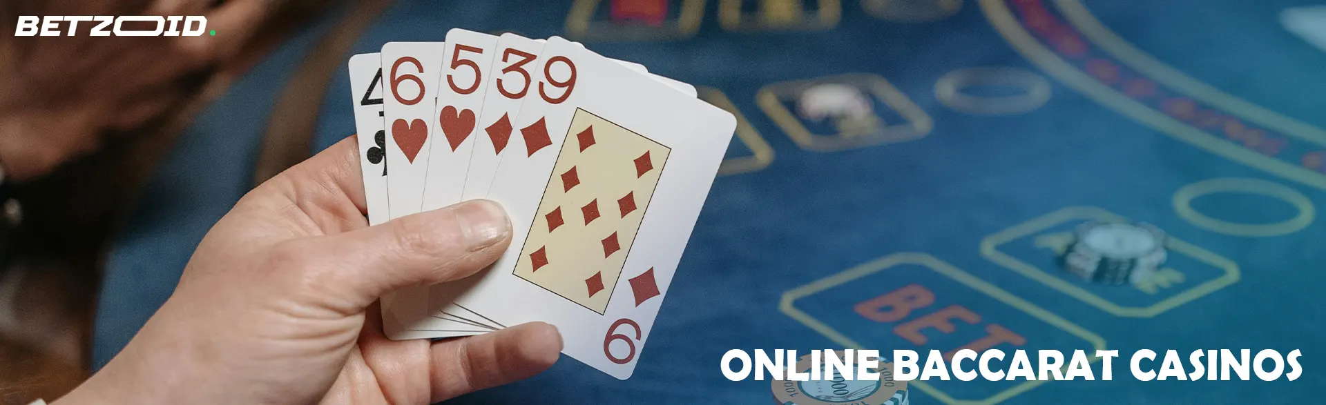 Player holding cards on casino table background.