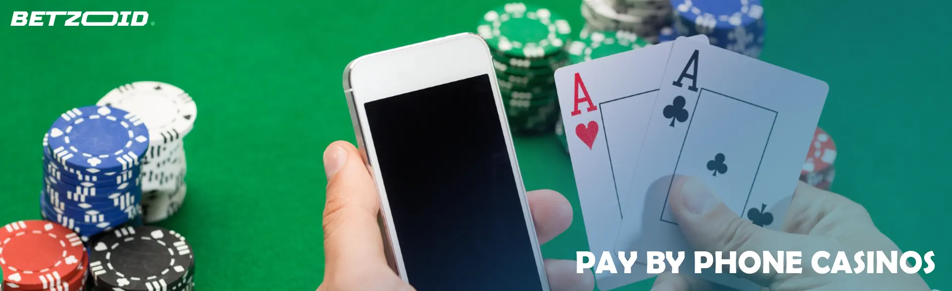 A smartphone and cards in the hands of a player on a background of casino chips.