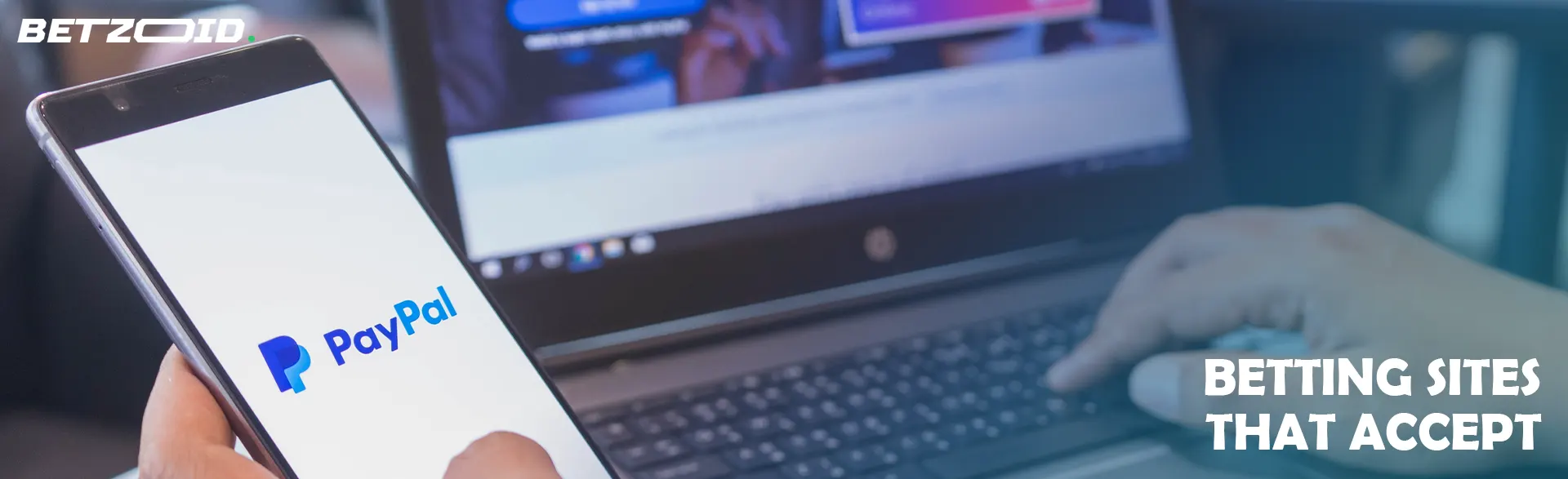Man holding phone with PayPal logo.