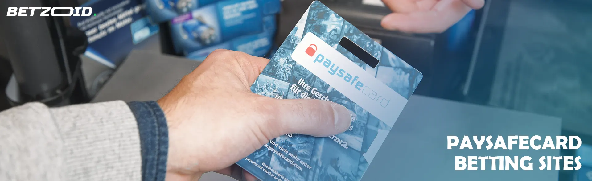 A person holds a Paysafecard in his hand.