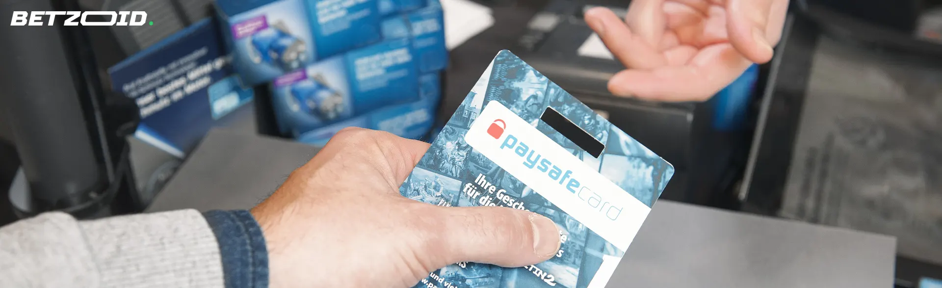 A person hands over a PaysafeCard.