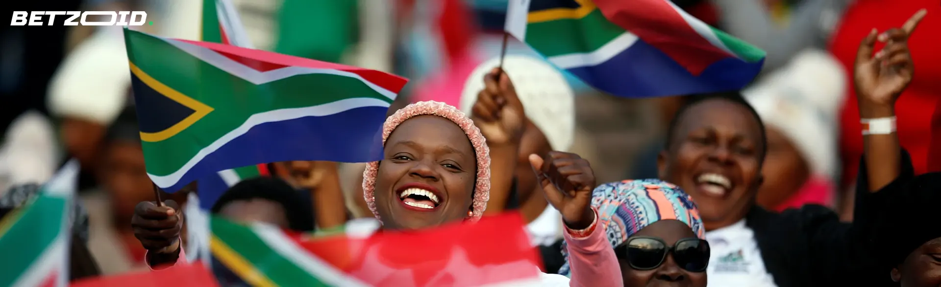 Residents of South Africa with the flags of their countries in their hands.