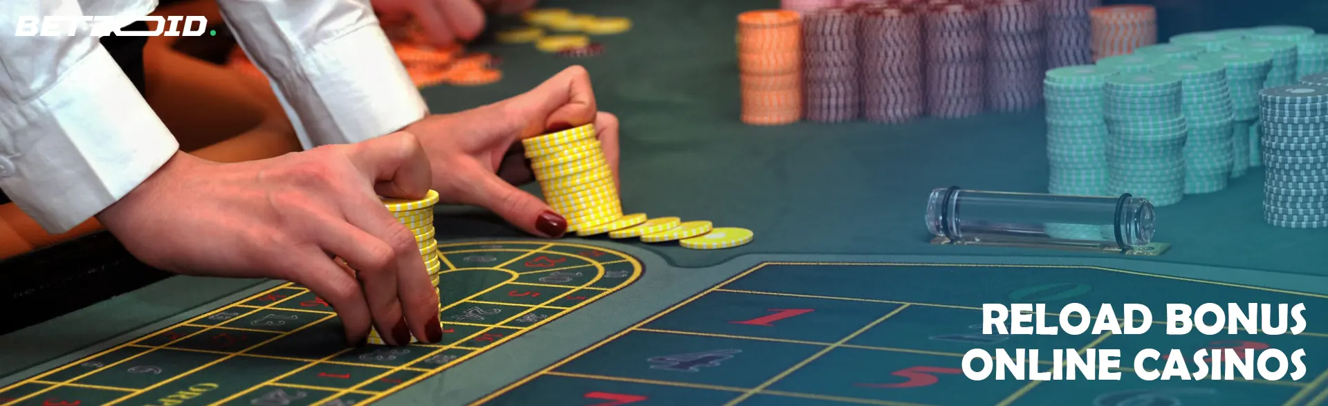 A player holds chips on a casino table.