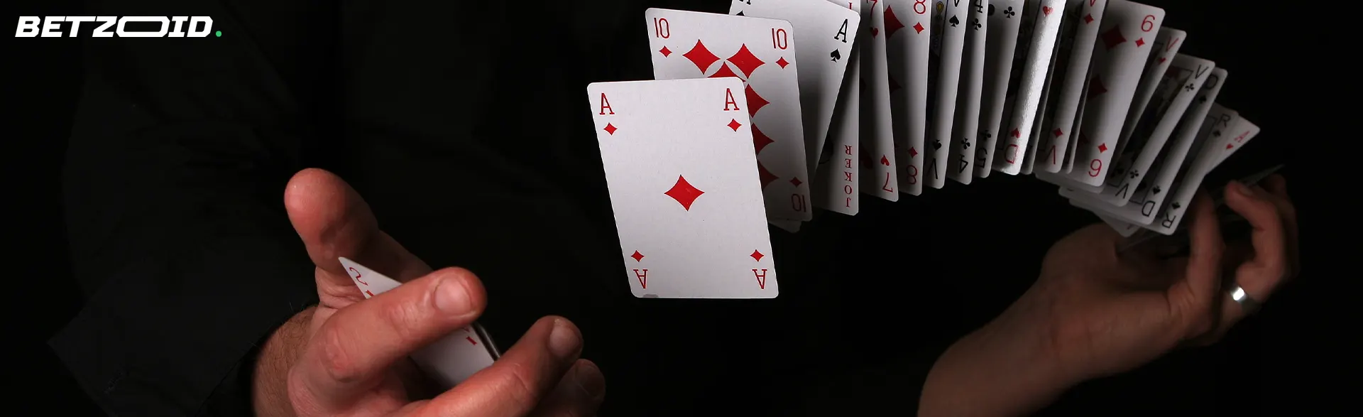 The player shuffles the cards in the air.