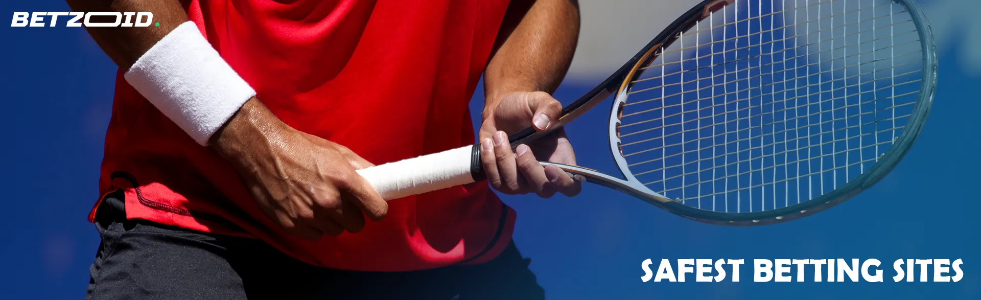 A tennis player holds a racket in his hands.