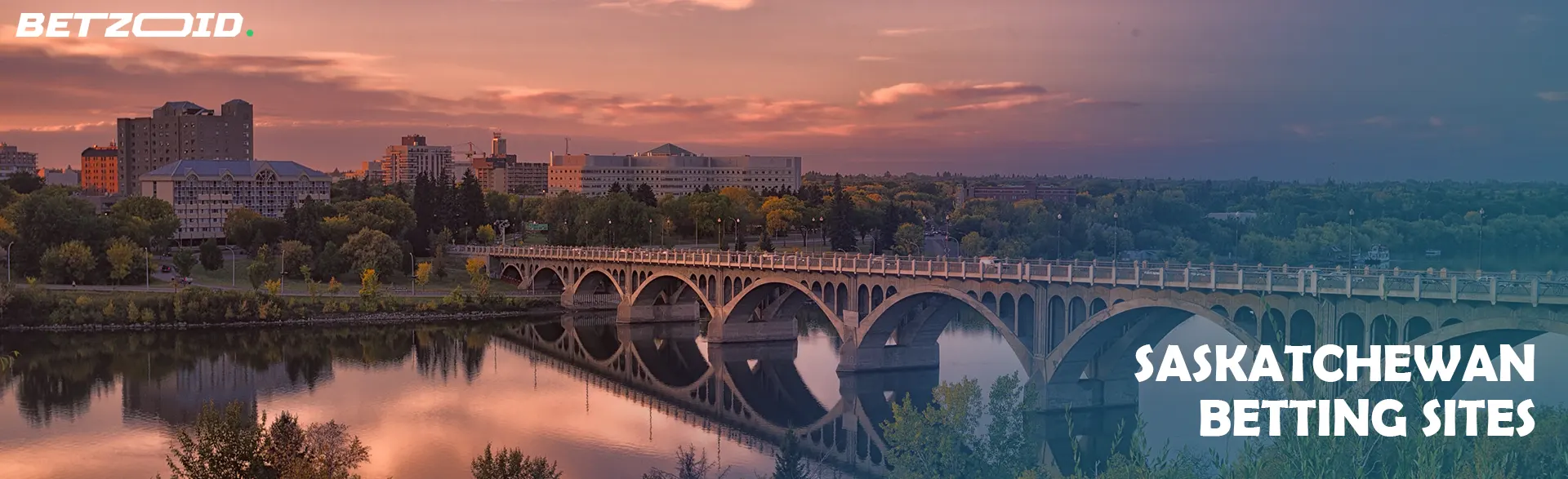 Scenic view of a bridge and cityscape in Saskatchewan at sunset, representing Saskatchewan betting sites.
