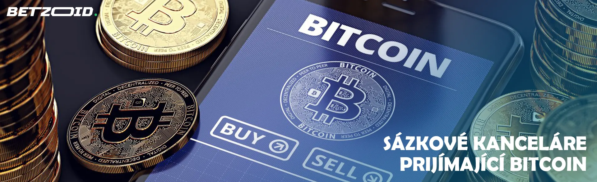 Bitcoinové mince vedle smartphonu.