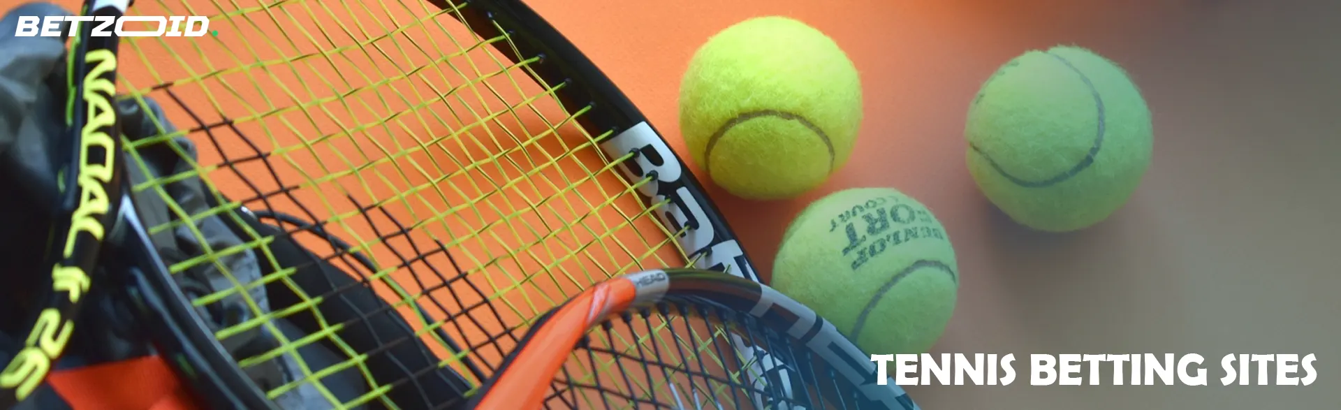 Tennis balls next to tennis rackets.
