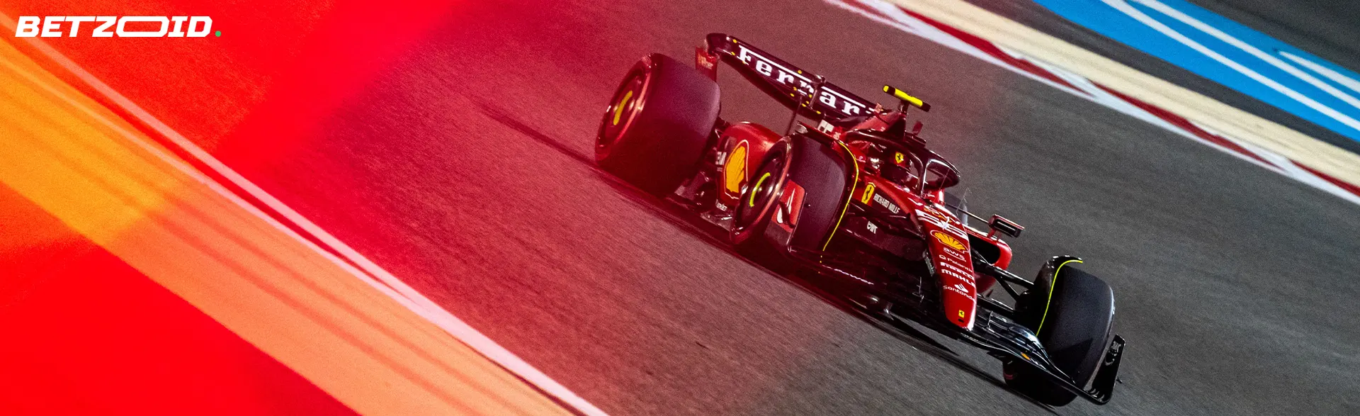 A red car on a high-speed turn of the track.